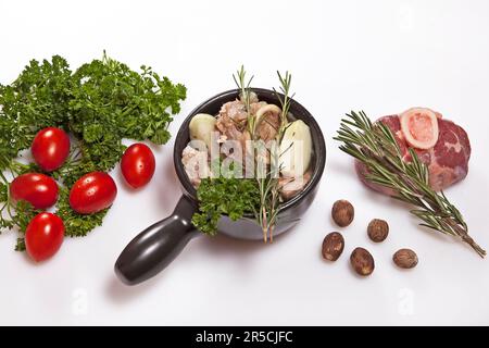 Ingredients for fresh beef stock, rosemary, parsley, tomatoes, nutmeg, beef, leg slice, beef stock, beef soup, soup meat, soup cup Stock Photo