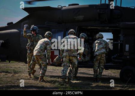 Soldiers assigned to 129th Area Support Medical Company and Forward Support MEDEVAC Platoon, 3rd Combat Aviation Brigade, 3rd Infantry Division conduct patient movement operations for aeromedical evacuation during a training while attending Saber Guardian 23 in Slobozia, Romania, June 1, 2023. Saber Guardian 23, a component of DEFENDER 23, is an exercise co-led by Romanian Land Forces and the U.S. Army at various locations in Romania to improve the integration of multinational combat forces by engaging in different events such as vehicle road marches, medical training exercises, and river cros Stock Photo