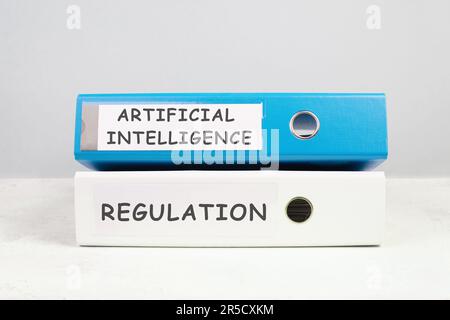Files with the words artificial intelligence and regulation, AI technology in competition with human resource, manpower against cyborg machine, replac Stock Photo