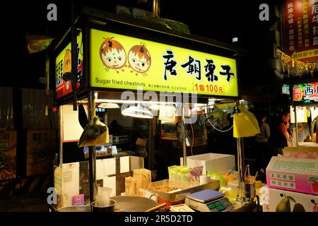 Sugar Fried Chestnuts stand at Huaxi Street Tourist Night Market in Taipei, Taiwan; street food cart in Taipei; traditional Taiwanese food. Stock Photo