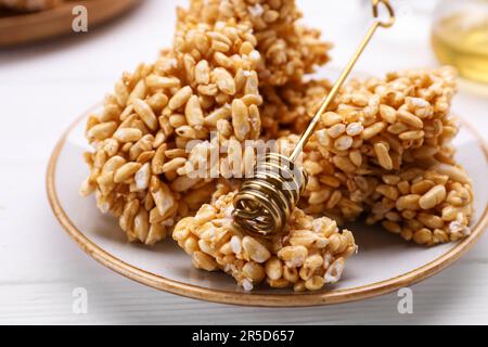 Puffed rice bars (kozinaki) on white plate, closeup Stock Photo