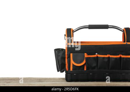 Empty bag for tools on wooden table against white background Stock Photo
