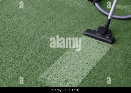 Vacuuming carpet. Clean area after using device, closeup Stock Photo