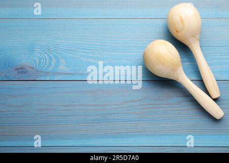 Maracas on light blue wooden table, top view with space for text. Musical instrument Stock Photo