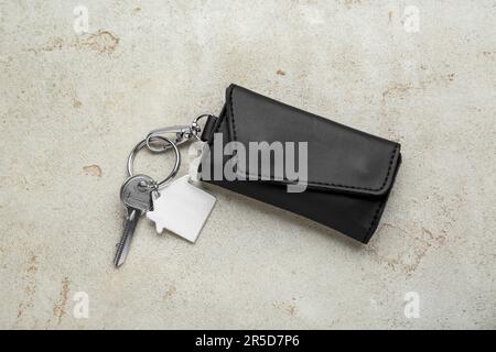 Leather case with key on light grey table, top view Stock Photo
