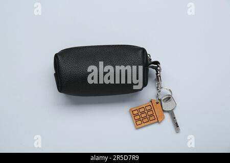 Leather case with key on light grey background, top view Stock Photo