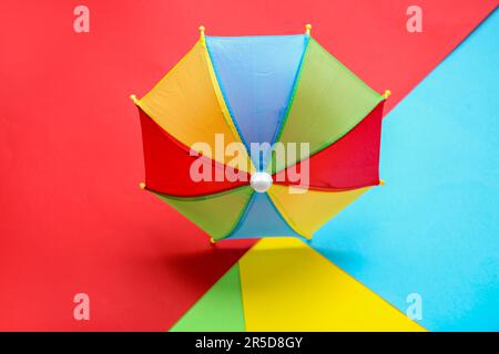 Colorful mini umbrella on color background Stock Photo