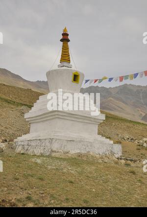 A Buddhist white stupa on rocky mountains of Ladakh, INDIA Stock Photo