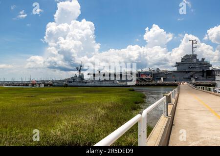 The United States Navy destroyer USS Laffey and aircraft carrier USS Yorktown sit beyond the marsh at Patriot's Point Naval and Maritime Museum. Stock Photo