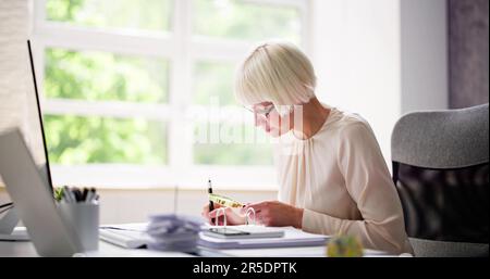 Corporate Auditor Using Magnifying Glass For Tax Fraud Audit Stock Photo
