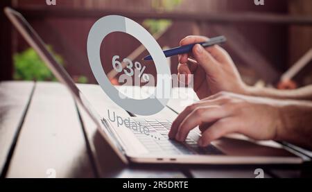 Man using laptop at the table. update the operating system to a newer one. Systems engineer Stock Photo
