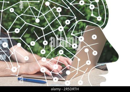Man working on laptop in garden. Closeup of male hands typing on computer Stock Photo