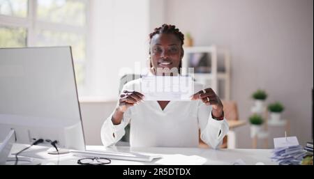 Holding Paycheck Or Payroll Check Or Insurance Cheque In Hand Stock Photo