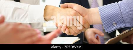 Welcome to our team and conclusion of business contract. Business people shaking hands while working in creative office Stock Photo