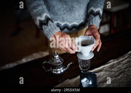 Life is like coffee, its what you make of it. a man preparing coffee in his kitchen. Stock Photo