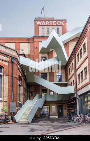 Basel, Switzerland, November 15, 2021. Renovation of the old Warteck brewery with a modern metal staircase from outside. It has become a house for man Stock Photo