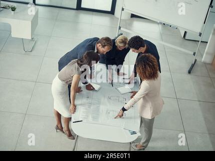 Perfection is in the details. a team of corporate architects collaborating on a plan in a modern office. Stock Photo