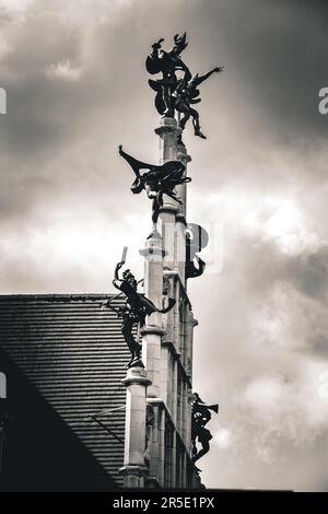 Dancing Harlequins on top of Masons' Guild Hall in Monochrome - Ghent, Belgium Stock Photo