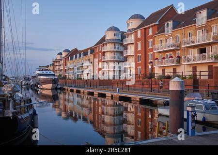 Eastbourne, East Sussex, United Kingdom - July 20 2021: Reflections of apartments and yachts in Sovereign Harbour Stock Photo