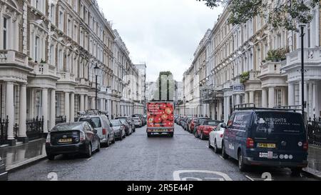 LONDON, UK - JUNE 21st, 2021: Tesco supermarket home delivery van parked on the street outside luxury Georgian terraced townhouses. Tesco is a British Stock Photo