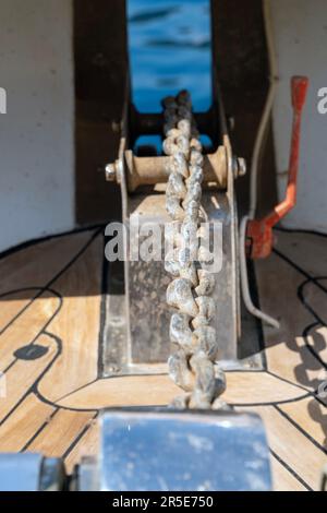 Close up view of an anchor chain from anchor winch on a sunny day. Stock Photo