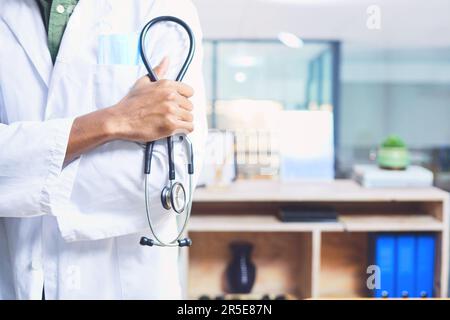 My stethoscope is never out of reach. an unrecognizable male doctor standing with his stethoscope in the hospital. Stock Photo