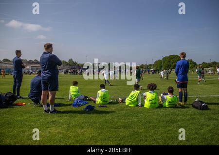 Boys playing organised grassroots football and soccer in UK on sunny day. Stock Photo