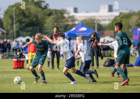 Boys playing organised grassroots football and soccer in UK on sunny day. Stock Photo