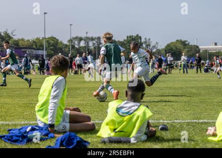 Boys playing organised grassroots football and soccer in UK on sunny day. Stock Photo