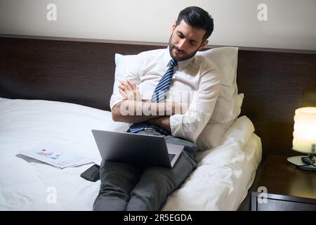 Manager in office clothes fell asleep at work over documents Stock Photo