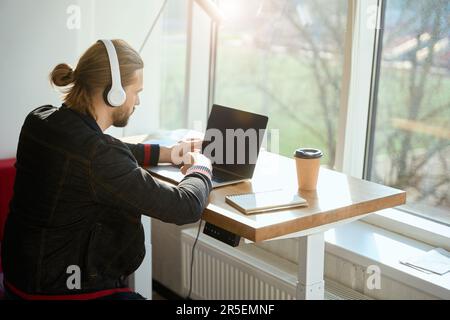 Concentrated worker doing work tasks in modern room Stock Photo
