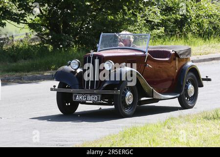 1937 30s thirties Red Black MORRIS Sedan 885 cc open-topped roadster travelling in Chorley UK Stock Photo