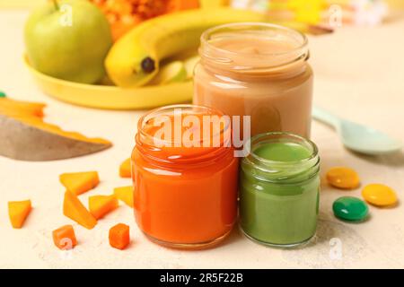 Jars of healthy baby puree on color background Stock Photo