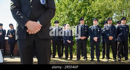 Eschede, Germany. 03rd June, 2023. Members of local fire departments stand in front of the memorial to the victims of the Eschede ICE accident on the 25th anniversary. On June 03, 1998, after a wheel tire broke in Eschede, Lower Saxony, several carriages of an ICE train crashed into a road bridge at a speed of 200. 101 people died. Credit: Gregor Fischer/dpa/Alamy Live News Stock Photo