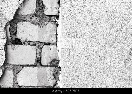Brick wall. Caving plaster with exposed bricks Stock Photo