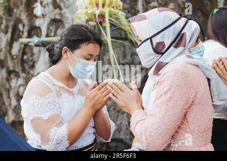 Muslim and all villagers shake hands and congratulate Buddhists who celebrate the holy day of Vesak in Thekelan village, Semarang regency, Indonesia Stock Photo