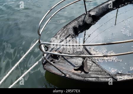 Maidenhead, UK. 3rd June, 2023. Two boats have been destroyed by fire in two separate incidents this week during the early hours of 31st May and 2nd June along the River Thames in Maidenhead, Berkshire. One of the charred wrecks remains cordoned off (pictured) and is now moored outside the riverside Chandlers Quay flats where there is a strong smell of fuel. The other boat that was destroyed by fire near to Boulter's Lock has, according to local residents, now sunk. Fortunately nobody was injured in the two fires. Thames Valley Police are reported to be making further investigations into alleg Stock Photo