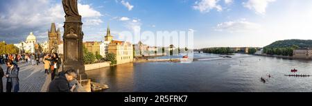 Prague, CZECH REPUBLIC - May 15th, 2023: The Moldau  / Vltava river in the middle of Prague, shot  from the Charles Bridge which is visible to the lef Stock Photo