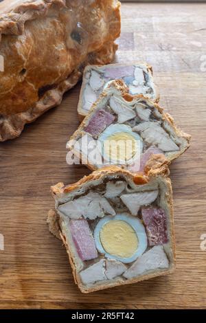 Front view of three tantalising slices of Chicken Ham and Egg Pie, arranged closely together, captured from a vertical angle. Stock Photo