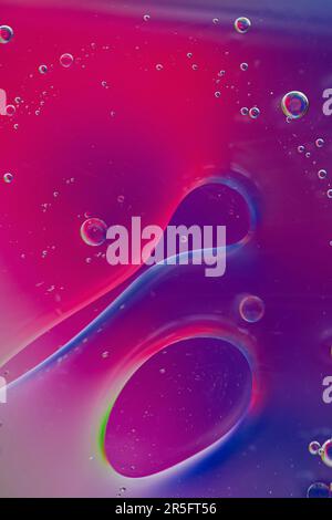 Oil on water with a coloured background. Stock Photo