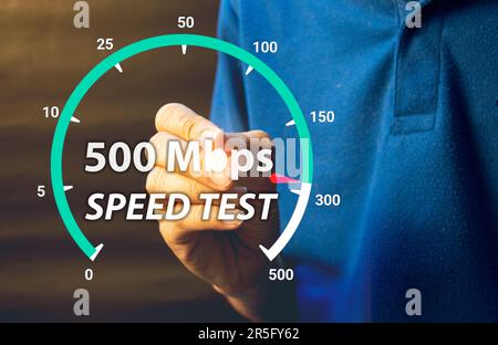 fast internet connection speedtest network bandwidth technology Man using high speed internet with smartphone and laptop computer. 5G quality, speed o Stock Photo