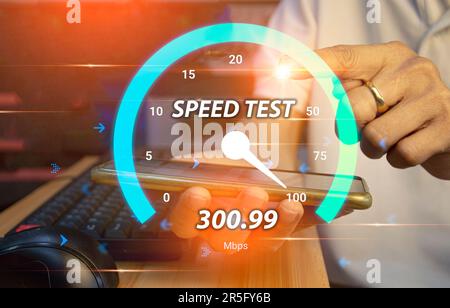fast internet connection speedtest network bandwidth technology Man using high speed internet with smartphone and laptop computer. 5G quality, speed o Stock Photo