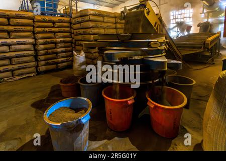 Sorting machine for tea. In the background bulk packs for international trade. Satemwa tea and coffee plantation near Thyolo, Malawi Stock Photo