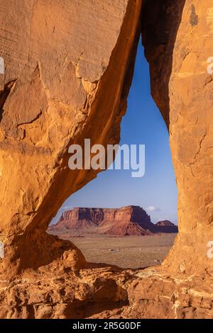 Sunset Image through Teardrop Arch at Monument Valley Navajo Tribal Park, Arizona, United States Stock Photo