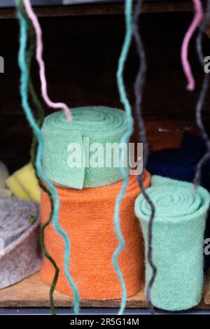 Colourful ribbons of felt are rolled up into snails. Stock Photo