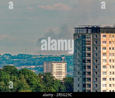 Glasgow, Scotland, UK 3rd June, 2023. Firefighters are tackling the blaze near Calderside Road, between Blantyre and East Kilbride. Big fire in south east  of the town over the hills about 20 miles away viewed from the west end of the city over the lincoln road towers. Credit Gerard Ferry/Alamy Live News Stock Photo