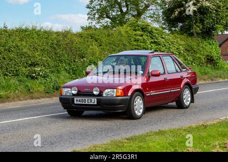 1990 Red Ford Escort Eclipse Classic vintage car, Yesteryear motors en route to Capesthorne Hall Vintage Collectors car show, Cheshire, UK 2023 Stock Photo