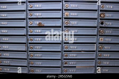 Old mailboxes on the wall in the entrance of an apartment building Stock Photo