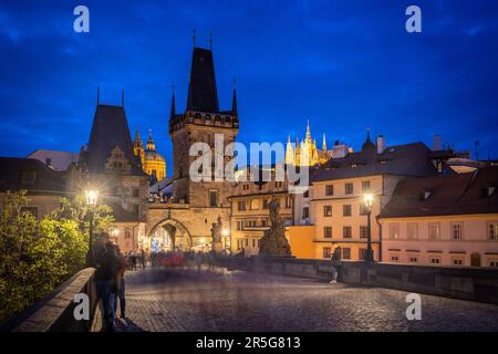 Prague: View to the Mala Strana area with western bridge tower of charles bridge, St. Nicholas Church and St. Vitus Cathedral during blue hour - passe Stock Photo