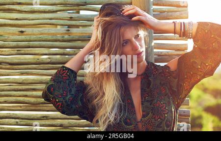 She has that special something. a fashionable young woman posing against a wooden partition. Stock Photo